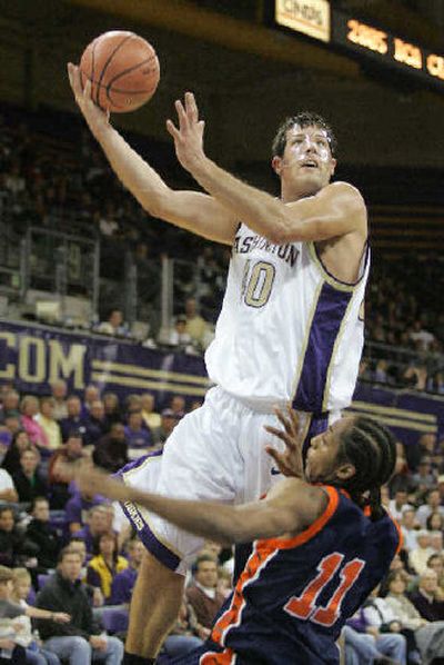 
Jon Brockman goes to the basket over Morgan State's Rogers Barnes II. 
 (Associated Press / The Spokesman-Review)