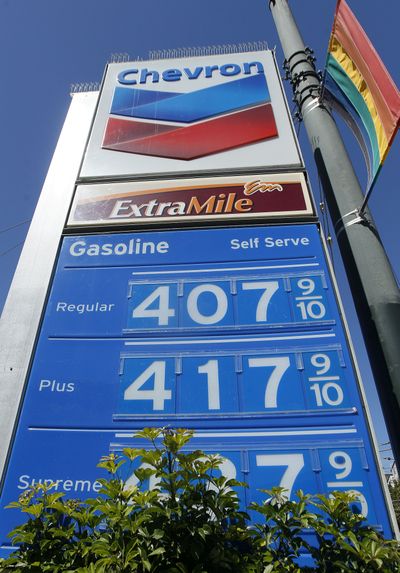 A Chevron gas station price board is displayed in San Francisco this week. A major refinery fire that sent plumes of black smoke over the San Francisco Bay area will help trigger a rise in oil and gas prices in California and elsewhere on the West Coast, analysts say. (Associated Press)