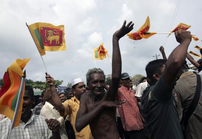 Sri Lankans display the national flags and celebrate  in Colombo, Sri Lanka, on Sunday.  (Associated Press / The Spokesman-Review)