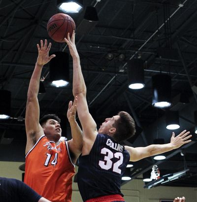 Gonzaga forward Zach Collins, right, blocks a shot by Pepperdine forward Chris Reyes during the second half of an NCAA college basketball game, Saturday, Jan. 28, 2017, in Malibu, Calif. Gonzaga won 96-49. (Ringo H.W. Chiu / Associated Press)