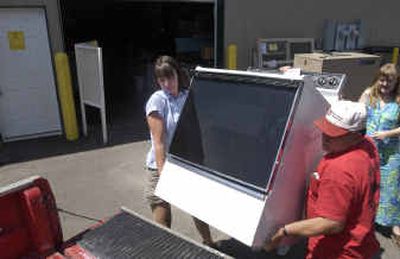 
Kim Buffin, left, and John Clark load a used stove into a customer's pickup at the Habitat for Humanity building supply thrift store in Post Falls. Kim Buffin, left, and John Clark load a used stove into a customer's pickup at the Habitat for Humanity building supply thrift store in Post Falls. 
 (Jesse Tinsley/Jesse Tinsley/ / The Spokesman-Review)