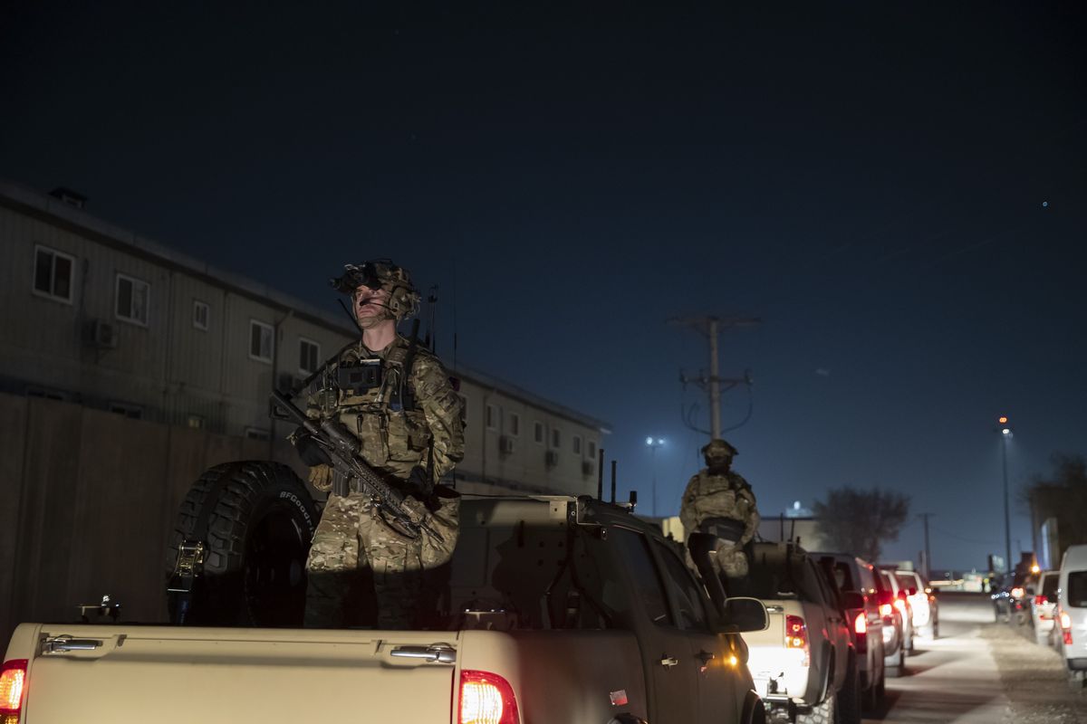 FILE - In this Nov. 28, 2019, file photo armed soldiers stand guard in the motorcade for President Donald Trump speaks during a surprise Thanksgiving Day visit to the troops at Bagram Air Field, Afghanistan. Without coming right out and saying it, President Joe Biden seems ready to let lapse a May 1 deadline for completing a withdrawal of U.S. troops from Afghanistan. Orderly withdrawals take time, and Biden is running out of it.  (Alex Brandon)