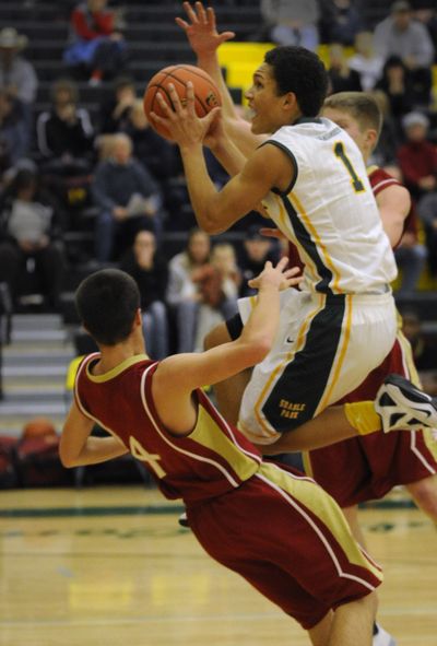 Shadle Park's Kionte Brown, right, draws a foul from University's Jared Miller. (Colin Mulvany)