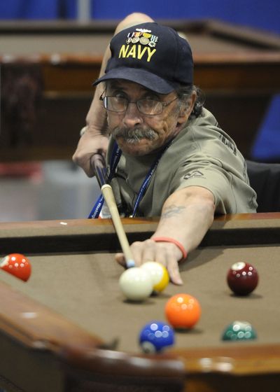 Bud Bemis eyes a shot during a game of 9-ball at the National Veterans Wheelchair Games. (Dan Pelle / The Spokesman-Review)