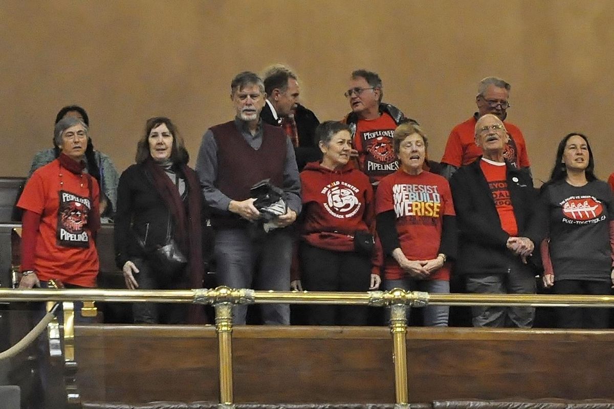 OLYMPIA – Environmental protesters in the gallery interrupt the opening ceremonies of the House of Representatives by chanting “We are in a climate crisis!” House Speaker Frank Chopp eventually ordered the protesters out of the gallery. (Jim Camden / The Spokesman-Review)