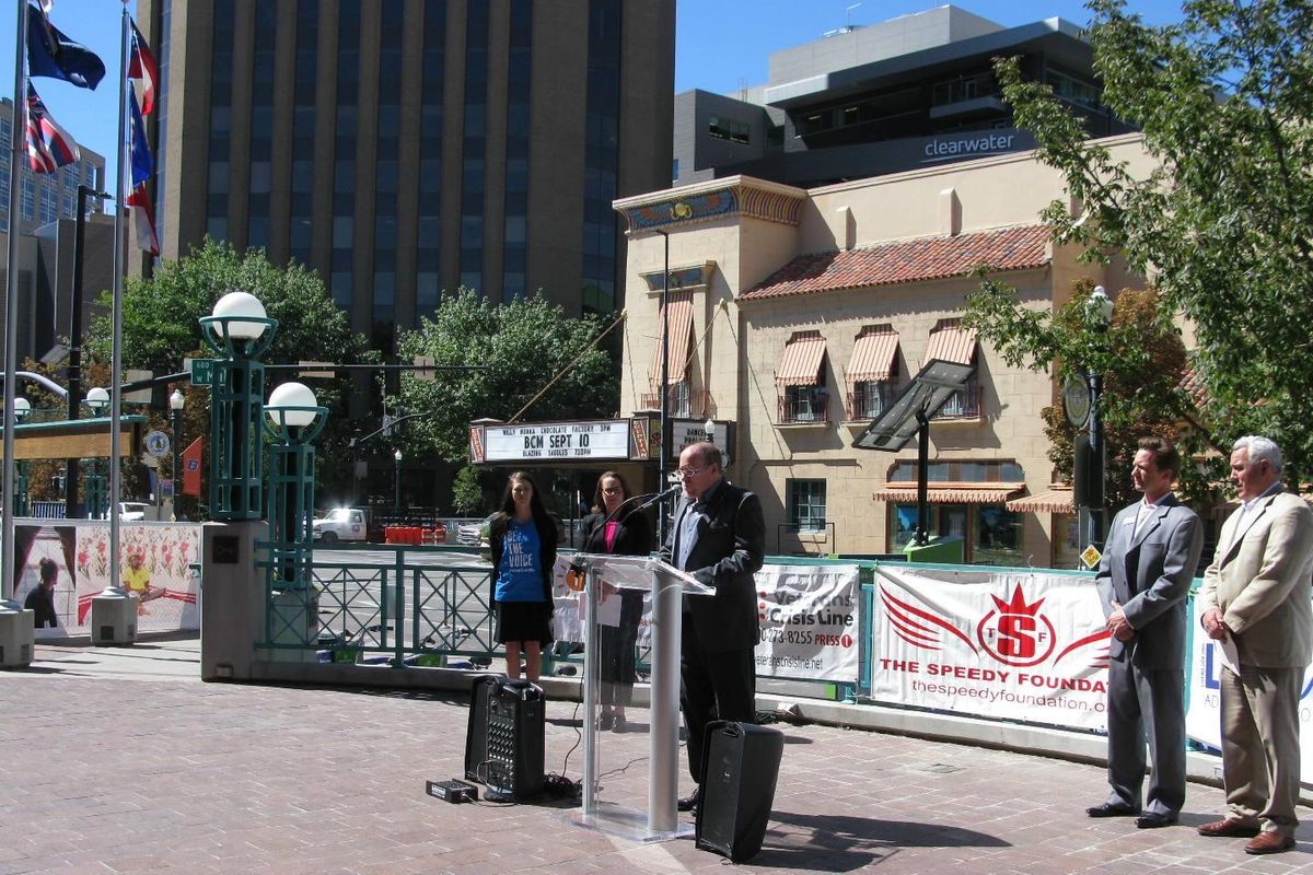John Reusser, director of the Idaho Suicide Prevention Hotline, speaks Thursday on the steps of Boise City Hall; at right is Boise Mayor Dave Bieter (Betsy Z. Russell)