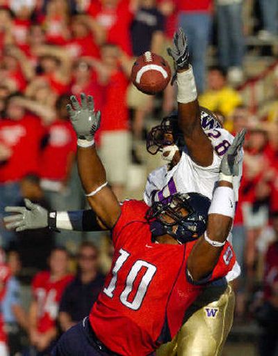 
UW's Roy Lewis jumps to knock a pass away from Arizona's Michael Thomas. 
 (Associated Press / The Spokesman-Review)