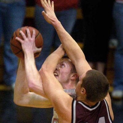 
EWU's Paul Butorac tries to get a peek at the basket, fighting through the tough defense of Montana's Andrew Strait.
 (CHRISTOPHER ANDERSON / The Spokesman-Review)