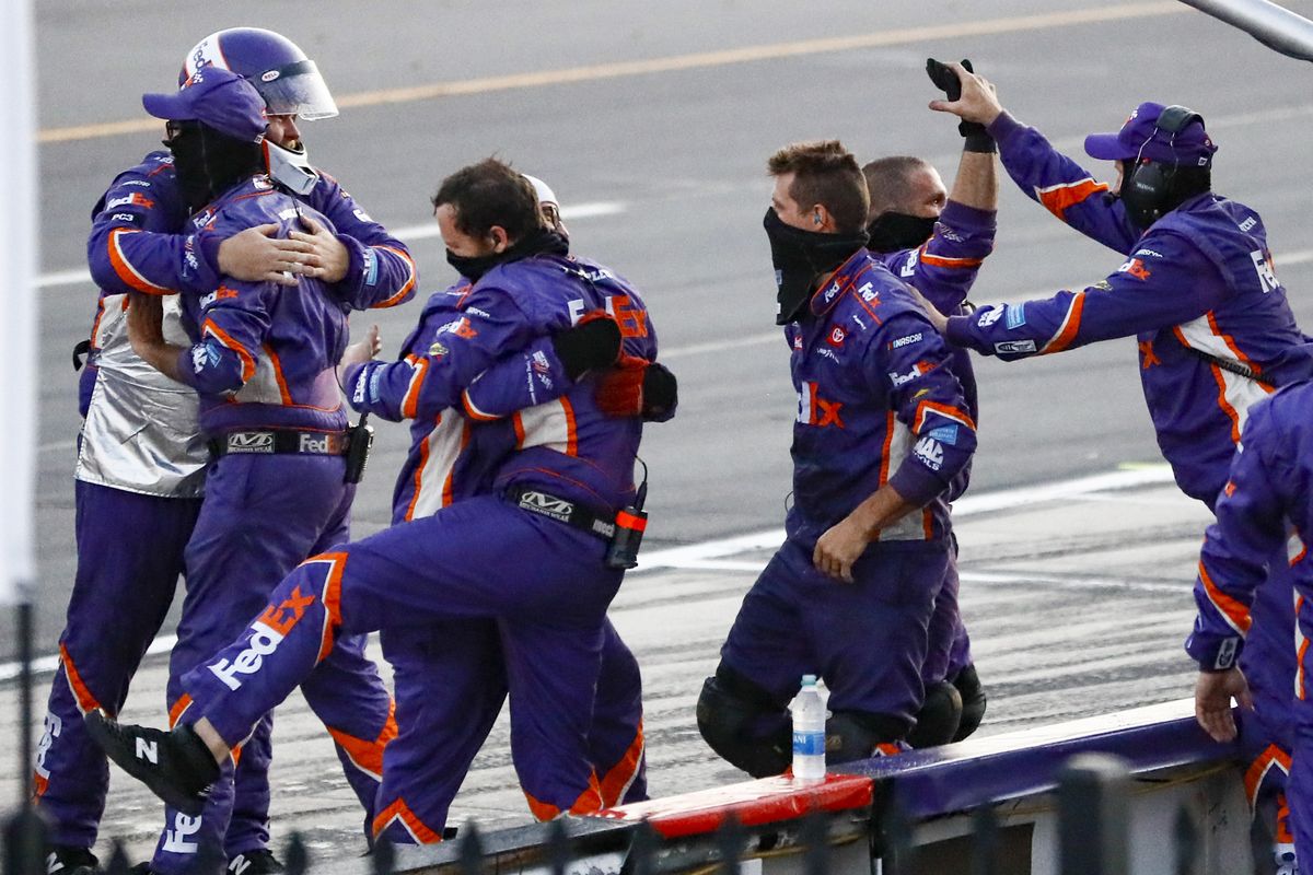 Crew members for Denny Hamlin celebrate Hamlin