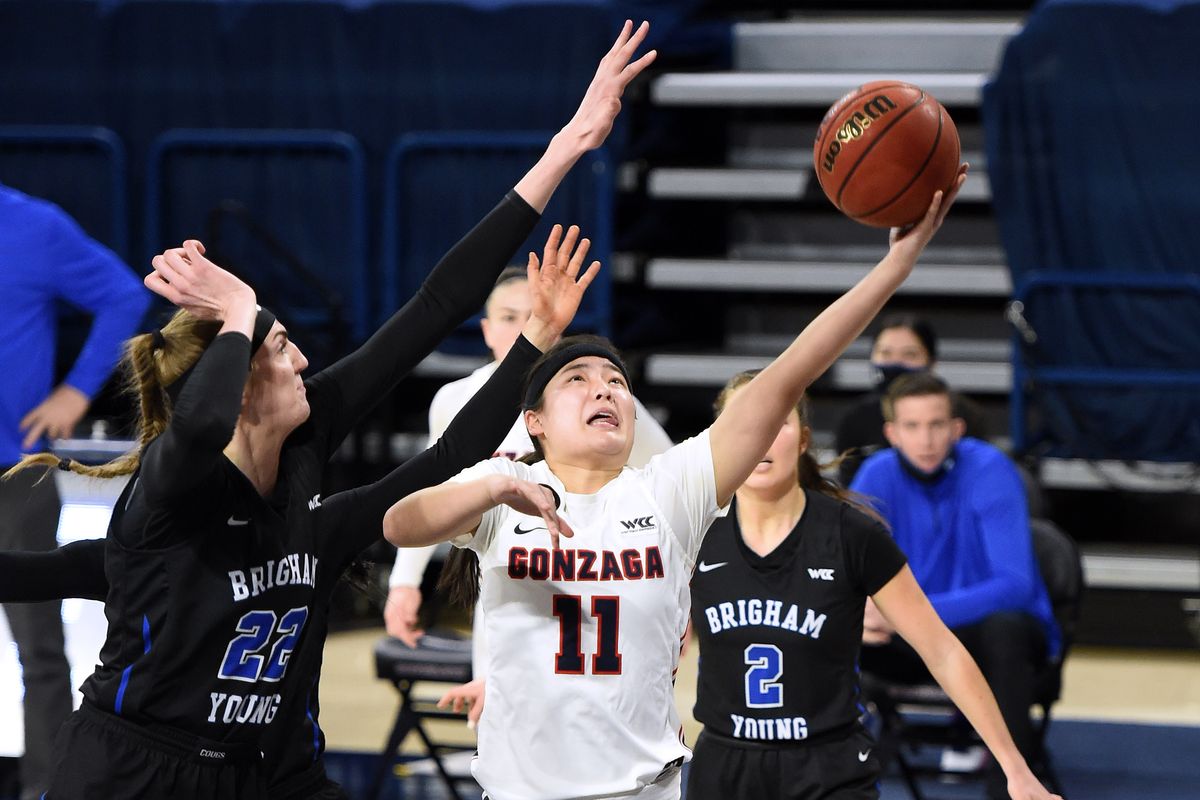 Gonzaga guard Kayleigh Truong (11) scores 2-points as BYU center Sara Hamson (22) defends during the first half of an NCAA college basketball game, Tuesday, Feb. 2, 2021, in the McCarthey Athletic Center.  (Colin Mulvany/THE SPOKESMAN-REVIEW)