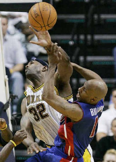 
Indiana's Dale Davis, left, hammers Detroit's Chauncey Billups as he goes up for shot on Sunday.
 (Associated Press / The Spokesman-Review)