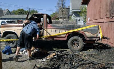 
Dan Rooney inspects the interior of his fire-damaged 1981 Ford F-250 pickup truck on Wednesday. A blaze reported behind his apartment at 1915 W. Boone early Wednesday morning was one of four fires in the area.
 (Dan Pelle / The Spokesman-Review)