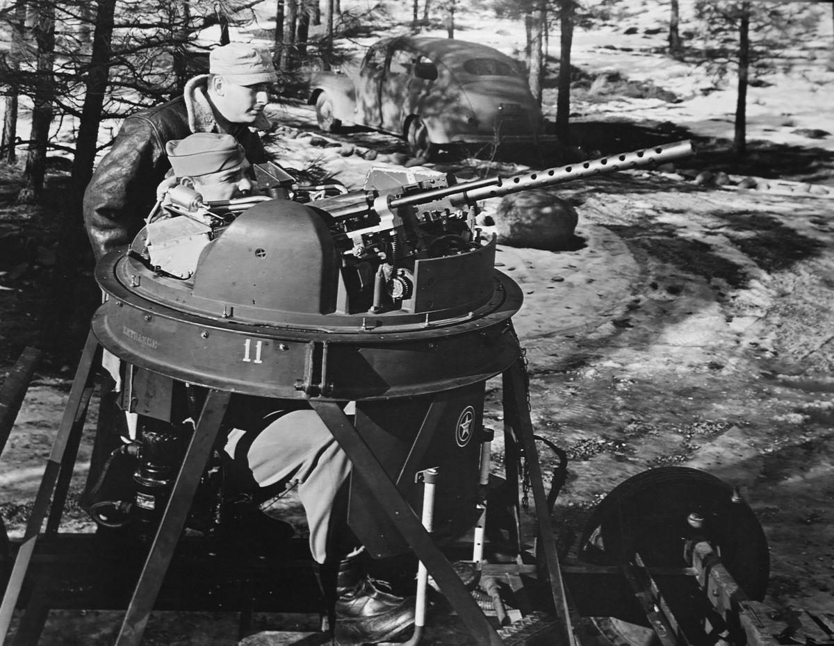 Movie actor Clark Gable sits in a turret gun simulator during gunnery training with gunnery sergeant Bill Willan in January 1943 at Camp Seven Mile near Spokane. The movie star was training as a turret gunner at Camp Seven Mile, which is now inside of Riverside State Park, and staying at Fort George Wright, though it wasn’t a part of his assignment, which was to make films for the war effort.  (Fairchild Air Force Base archive)