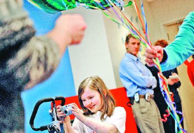 
Kaley Dugger, 10, takes a photo  at Sacred Heart Children's Hospital on Tuesday  at a send-off party for her. 
 (Jed Conklin / The Spokesman-Review)