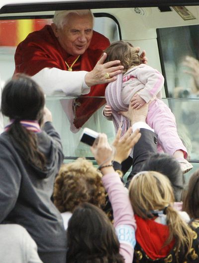Pope Benedict XVI reaches out to a child on his arrival at Royal Randwick Racecourse in Sydney, Australia, on Sunday.  (Associated Press / The Spokesman-Review)