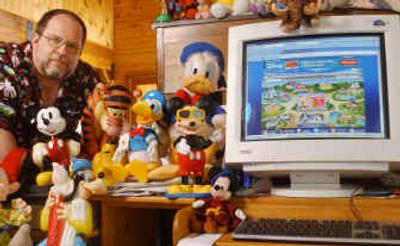 
Jim Hill poses with a variety of Disney artifacts at his home in New Hampshire. 
 (Associated Press / The Spokesman-Review)
