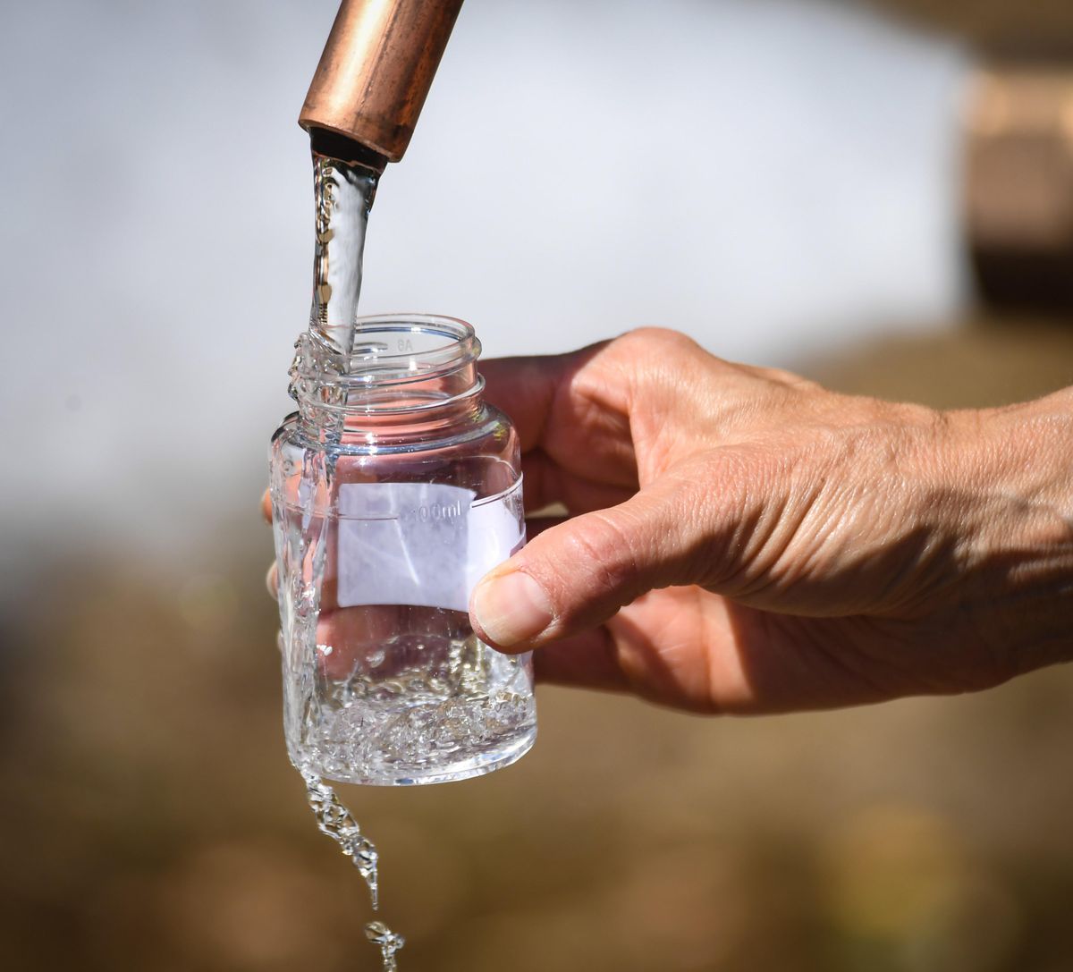 City of Spokane Water Department employees test water from a hydrant at the corner of Rebecca Street and Wellesley Avenue, Tuesday, July 30, 2019, in Spokane. The city is distributing bottles of water free to residents impacted by the contaminated water in the Hillyard neighborhood. (Dan Pelle / The Spokesman-Review)