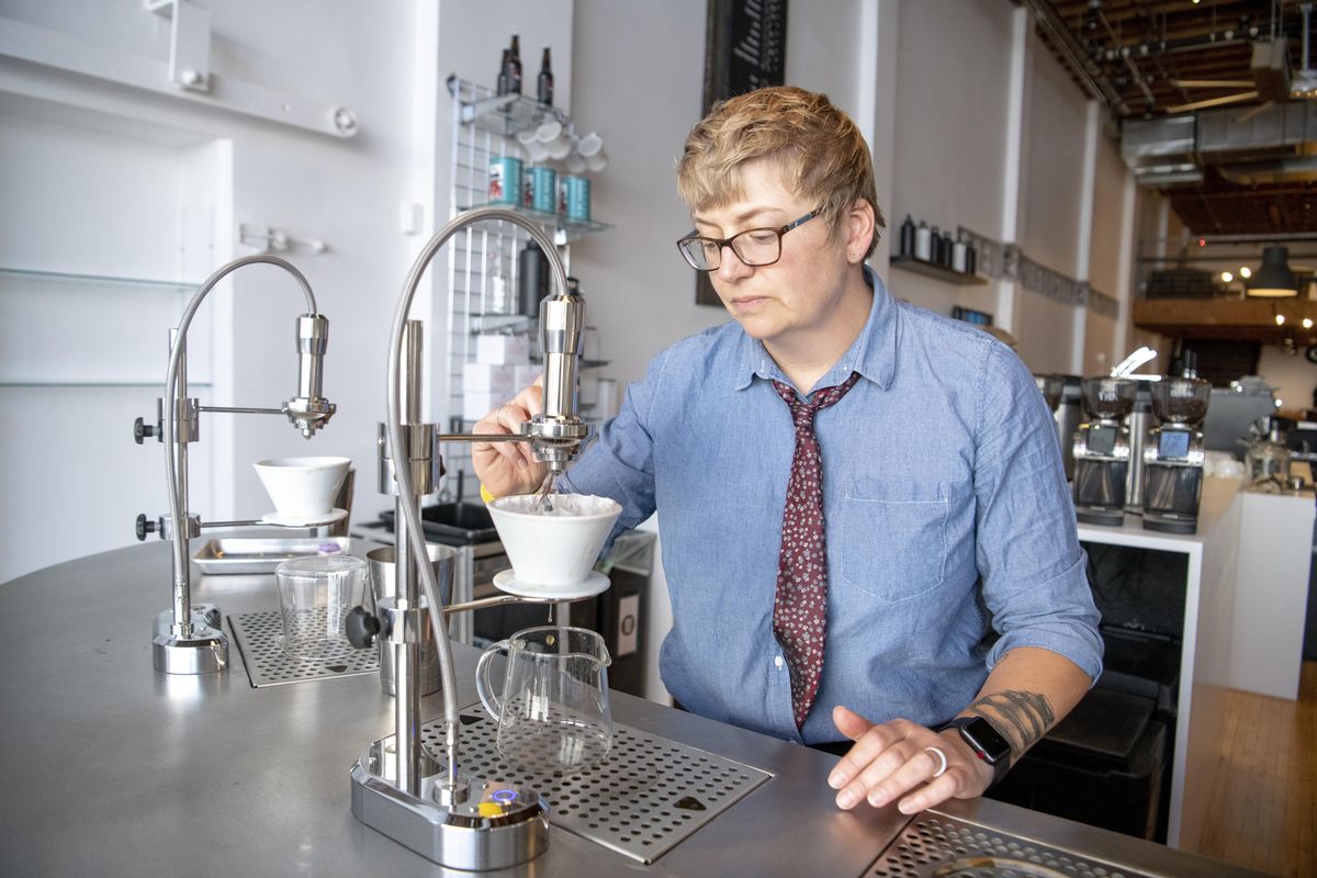 Manager Kristen Scott-Silver monitors a pour-over station as it brews coffee at 1st Ave. Coffee, Friday, Aug. 3, 2018, in downtown Spokane. (Jesse Tinsley / The Spokesman-Review)
