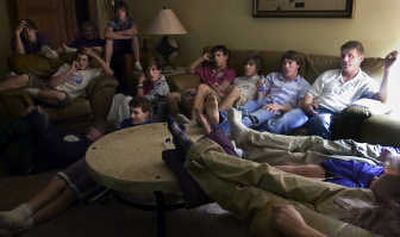 
After finishing plates of home-cooked spaghetti, the Valley Christian School football team finishes their pre-game ritual by watching a film of their next opponent at the Otis Orchards home of head coach Jim Puryear, far right. 
 (Holly Pickett / The Spokesman-Review)