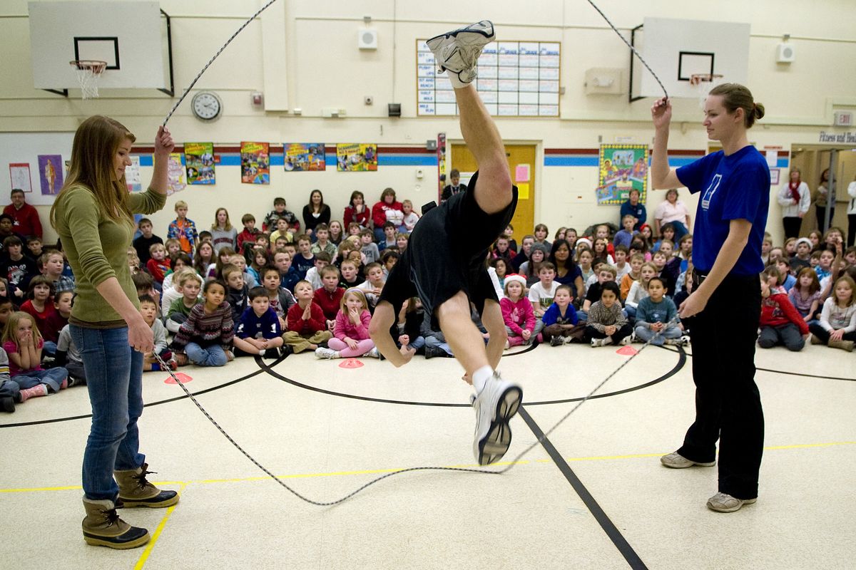 With the help of rope turners Lindsay Leaf, left, and Alicia Nestler, World champion jump-roper Peter Nestler performs at an assembly to build on the success of Balboa Elementary School’s jump-rope club. (Colin Mulvany)