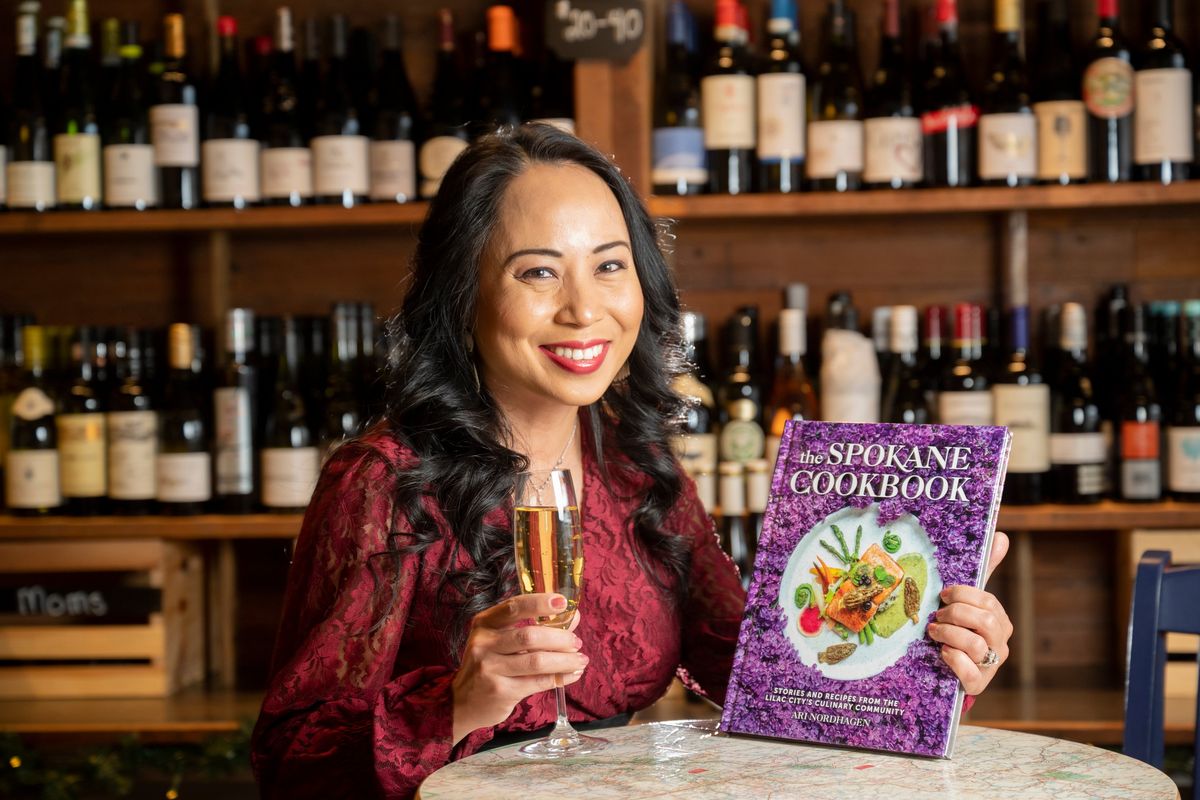 Food blogger, writer and author Ari Nordhagen shows off her first cookbook “The Spokane Cookbook” on Friday at Wanderlust Delicato in downtown Spokane. Her first printing of the book is selling out quickly after arriving just in time for Christmas shopping.  (Jesse Tinsley/THE SPOKESMAN-REVI)
