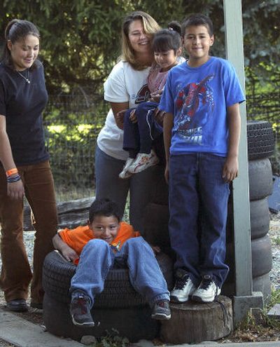 
The Gutierrez family, from left, KayLee, 12, Michael, 8, Krissy holding Alicia, 4, and Josiah, 9, make up Team 75. Krissy Gutierrez recently started racing stock cars, much to the amusement of her kids. Gutierrez's 1975 Nova  was stolen from her home. 
 (Liz-Anne Kishimoto / The Spokesman-Review)