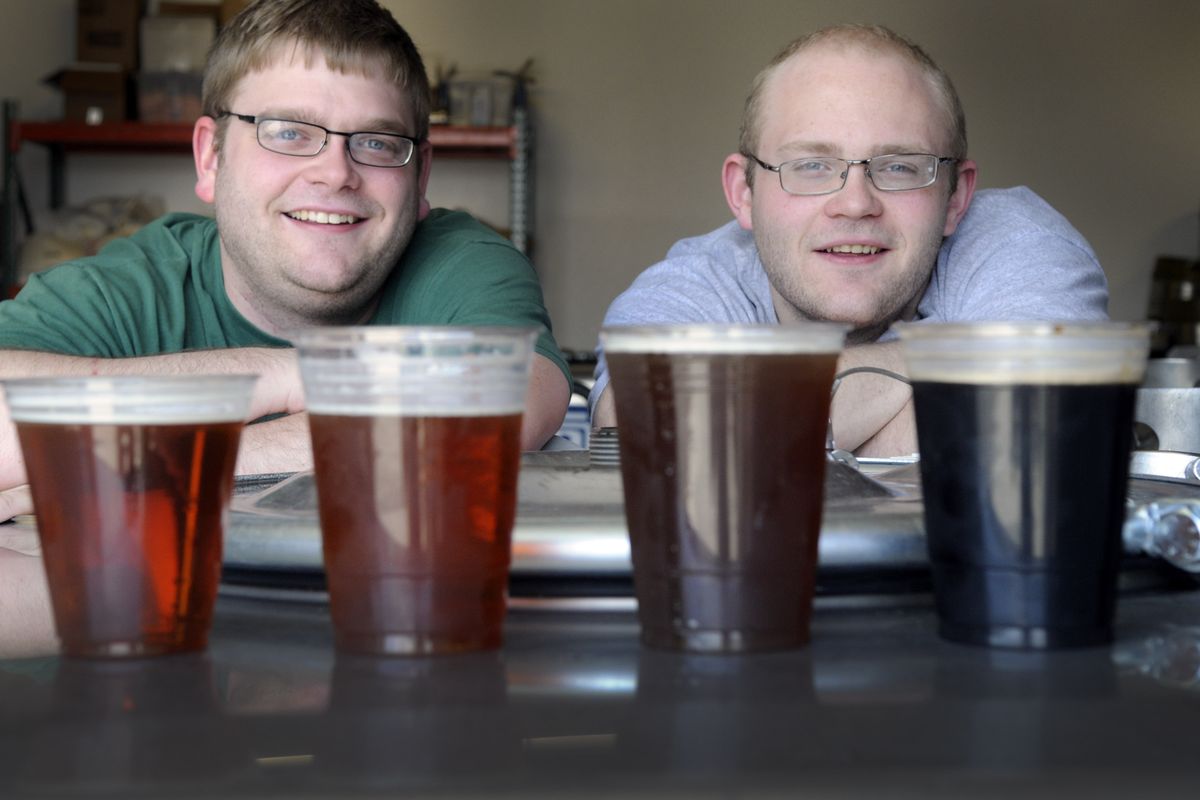Brad Budge, left, and his brother, Bruce, own and operate Budge Brothers Brewery on East Riverside Avenue in Spokane. The beers they brew include Spokamber, Orangutan Pale Ale, Hop Train and Extra Stout. (Christopher Anderson)