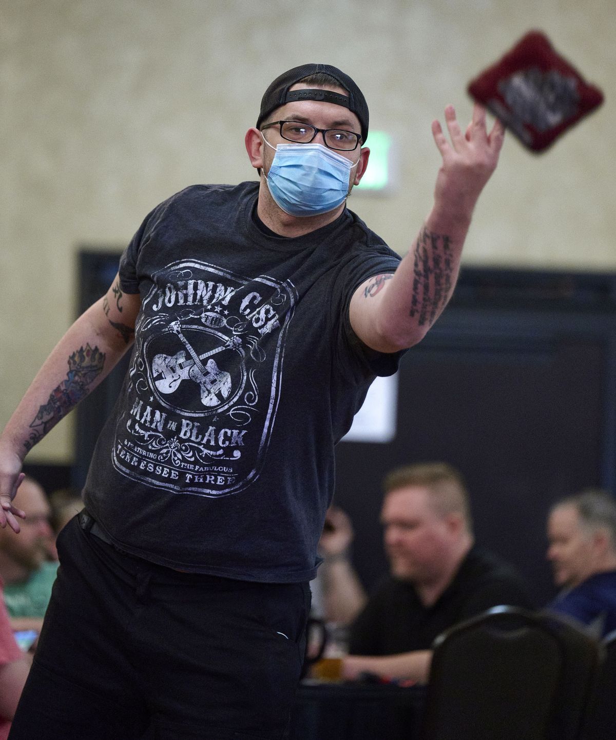 Jay Cook tosses a cornhole bag in the ballroom of the Mirabeau Hotel in the Spokane Valley on April 20. Spokane Cornhole meets Tuesdays and Wednesdays for spirited competition. $10 gets you six games.  (COLIN MULVANY/THE SPOKESMAN-REVIEW)