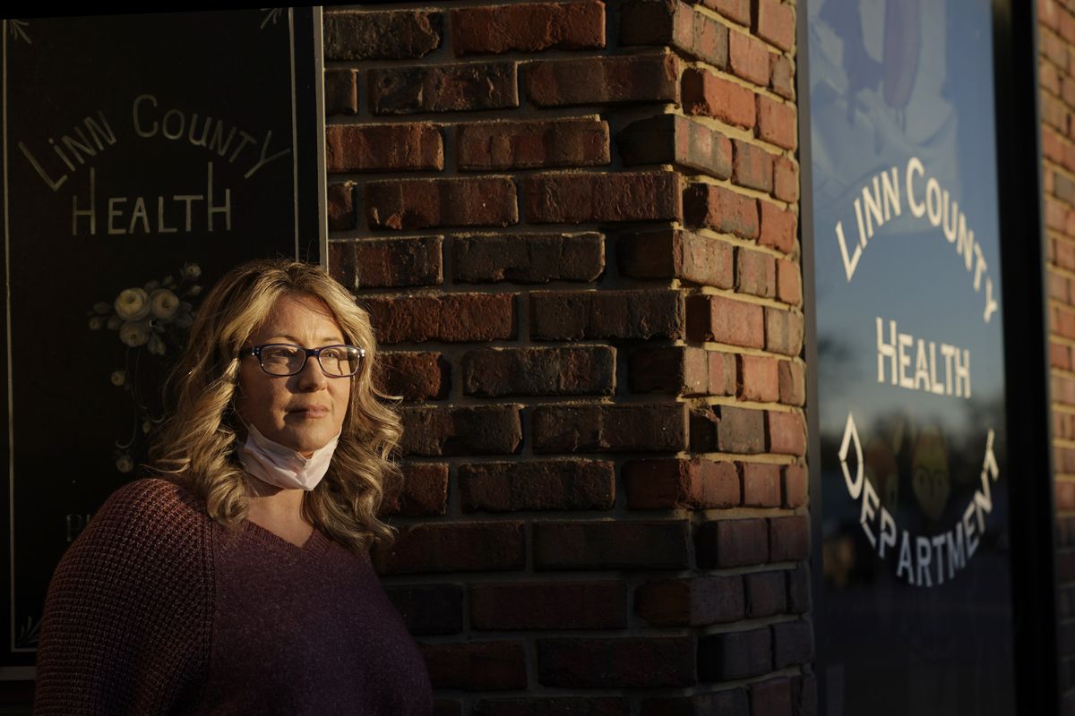 Tisha Coleman, public health administrator for Linn County, stands in front of her office Monday, Dec. 7, 2020, in Pleasanton, Kan. Across the United States, state and local public health officials such as Coleman have found themselves at the center of a political storm as they combat the worst pandemic in a century.  (Charlie Riedel)