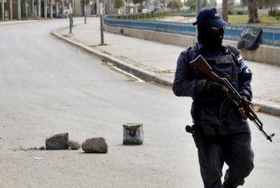 
An Iraqi policeman patrols Baqouba, Iraq, on Friday after two days of fighting  that erupted when insurgents attacked five police checkpoints, a police station and an Iraqi army headquarters. 
 (Associated Press / The Spokesman-Review)