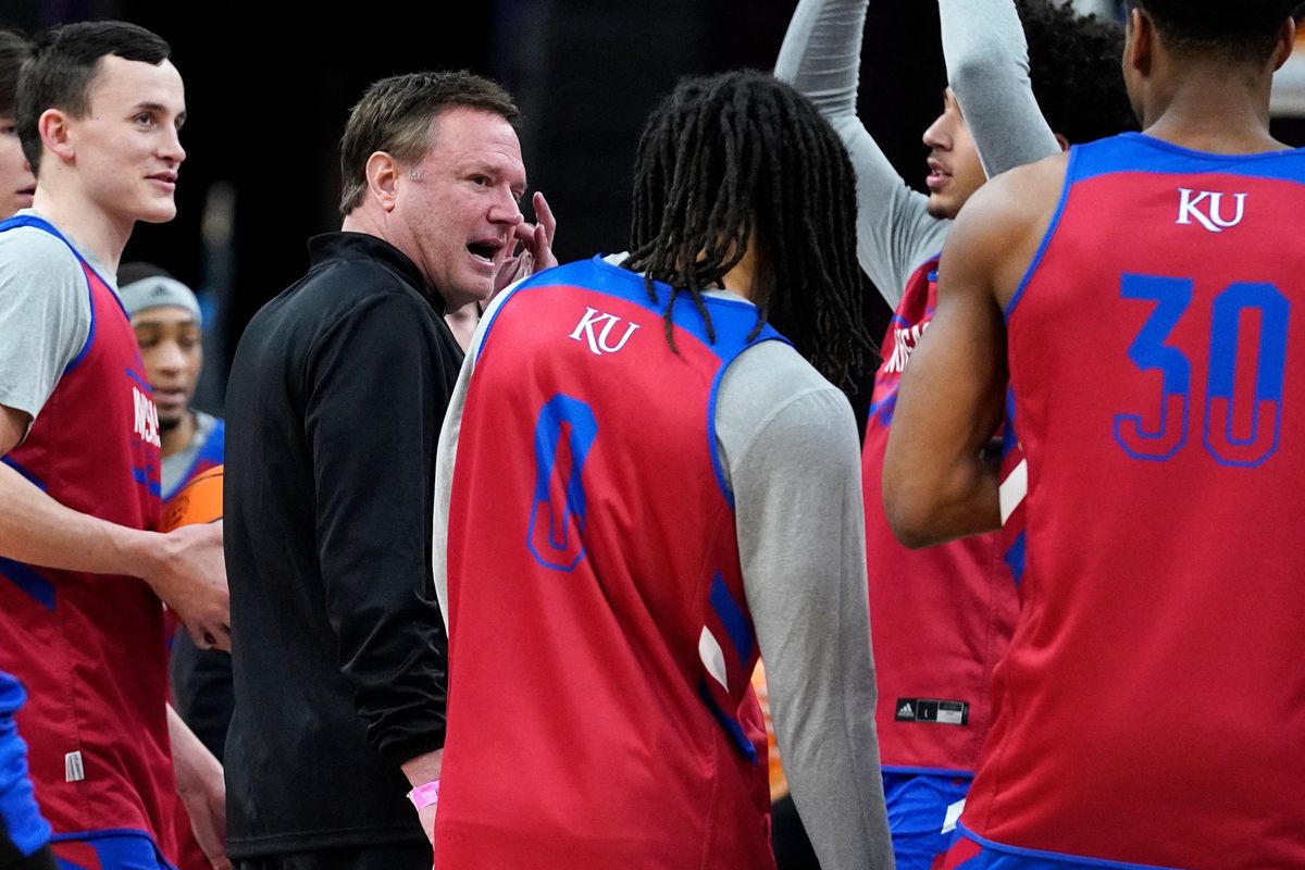 Kansas head coach Bill Self, second from left, talks with players during a practice for the NCAA men