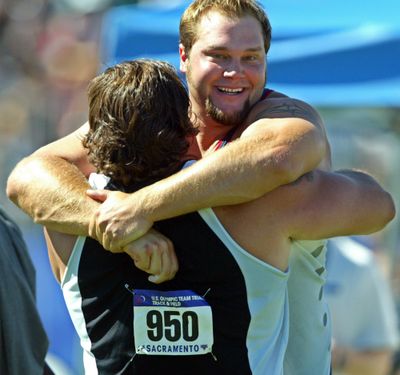 Ian Waltz hugs Jarred Rome (950) after the discus final during the Olympic Track and Field trials in Sacramento, Calif., Sunday, July 18, 2004. Rome placed first, and Waltz placed second. Snohomish County medical examiners ruled that the death of 42-year-old Jarred Rome in September 2019, was an accident after discovering fentanyl, KOMO-TV reported. (ERIC RISBERG / Associated Press)
