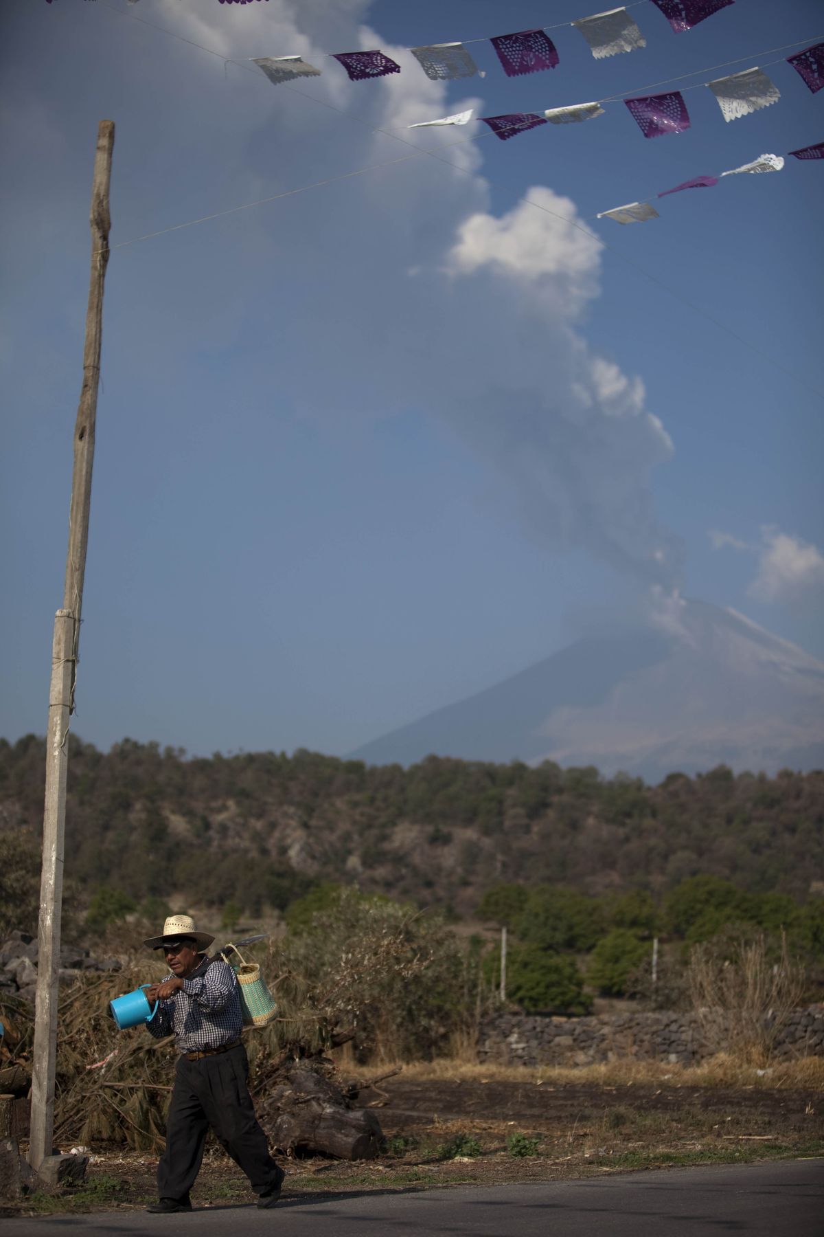 A plume of ash and steam rises from Popocatepetl volcano as seen from San Nicolas, Mexico, Friday, April 20, 2012. Mexico