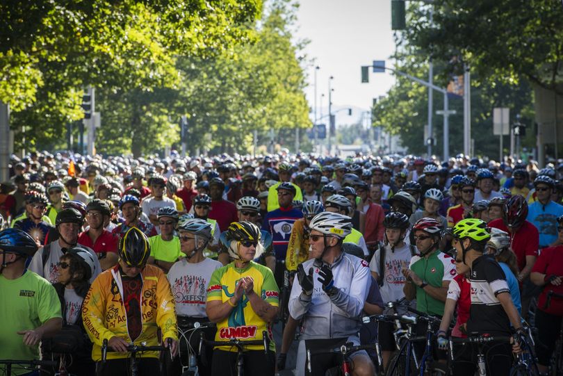 Riders gather at the starting line on Spokane Falls Boulevard during SpokeFest on Sunday in Spokane. (Colin Mulvany)