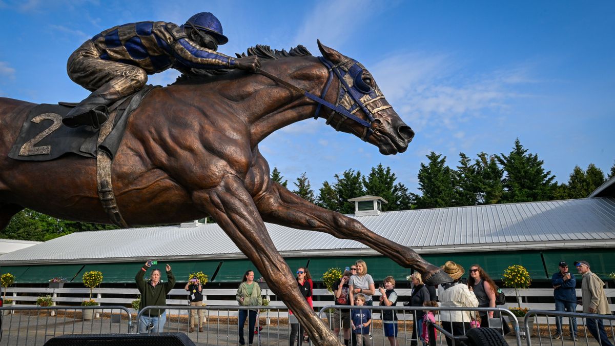 A statue of Triple Crown winner Secretariat by artist Jocelyn Russell catches the attention of visitors on a tour of Pimlico on Tuesday. Fifty years after Secretariat won the Preakness, racing lovers say there