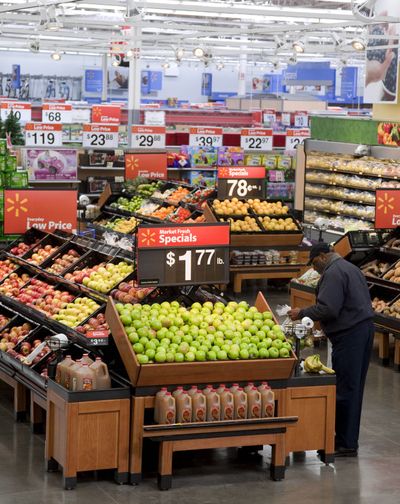 A customer selects food in the produce section of a Walmart store in Virginia. (Associated Press)