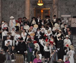 Dozens of Washington residents in period costume gather in the Capitol Rotunda to mark the centennial of women receiving the right to vote in the state. (Jim Camden/Spokesman-Review)