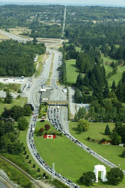 The Peace Arch, lower right, is shown from the air at the U.S.-Canada border crossing at Blaine, Wash., Aug. 20, 2004. (TED S. WARREN / Associated Press)