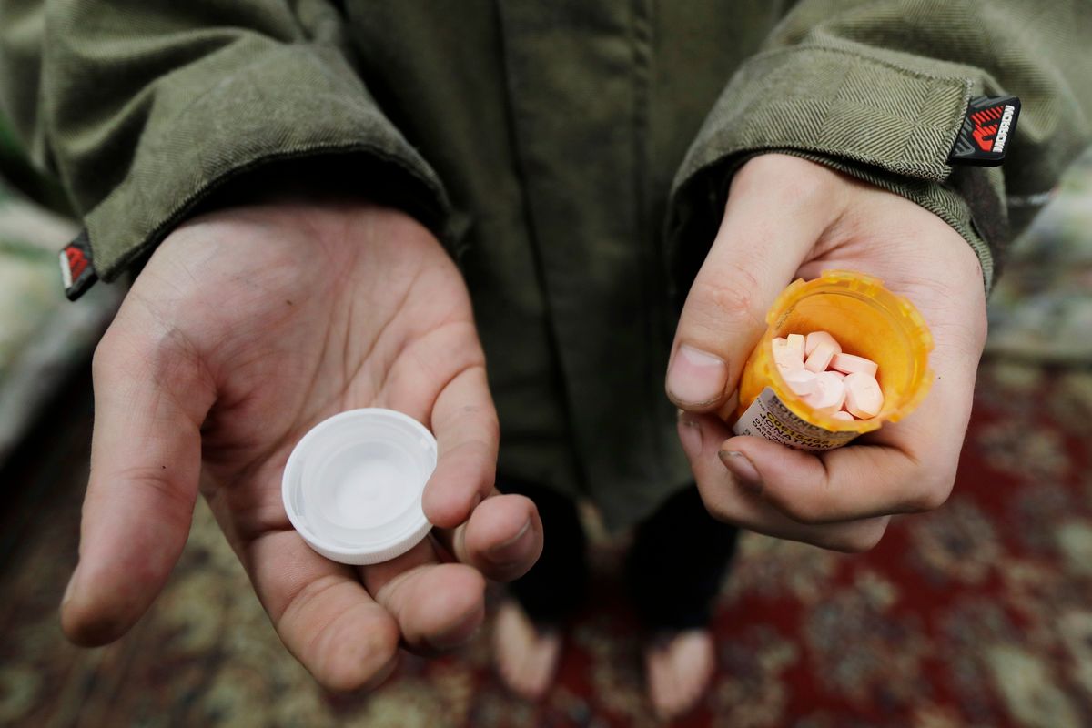 In this Nov. 14, 2019, photo, Jon Combes holds his bottle of buprenorphine, a medicine that prevents withdrawal sickness in people trying to stop using opiates, in a clinic in Olympia. The U.S. Department of Justice said April 2 that barring the use of medication treatment for opioid abuse is a violation of federal law.  (Ted S. Warren)