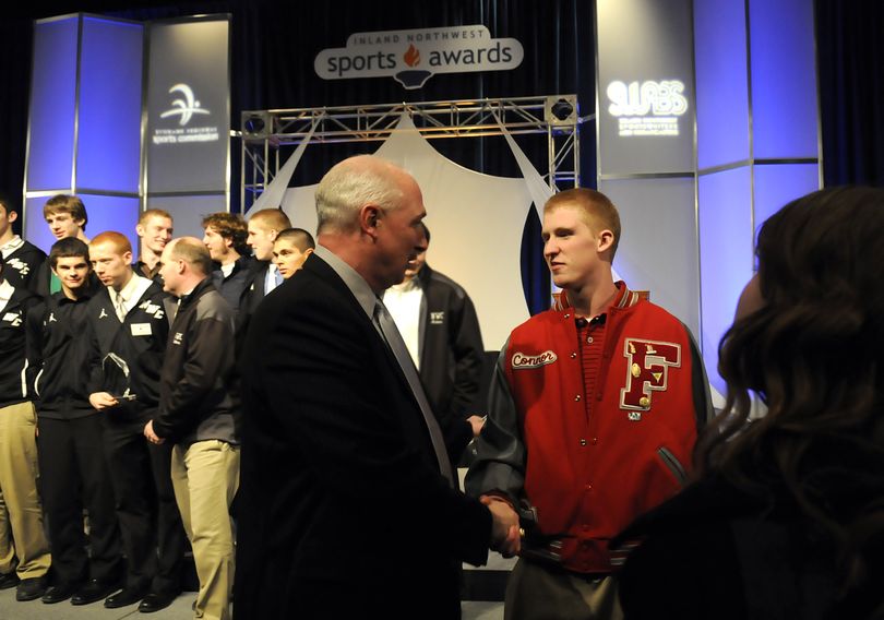 Idaho Coach Robb Akey, center, shakes hands with Ferris' Connor Halliday, right, at the end of the annual Inland Northwest Sports Awards luncheon Wednesday, Feb. 24, 2010 at the Spokane Convention Center. (Jesse Tinsley / The Spokesman-Review)