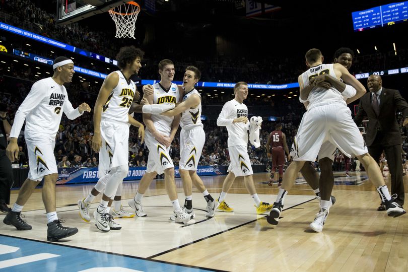 Iowa players celebrate after winning 72-70 in overtime of a first round men's college basketball game against Temple in the NCAA Tournament, Friday, March 18, 2016, in New York. (Mary Altaffer / Associated Press)