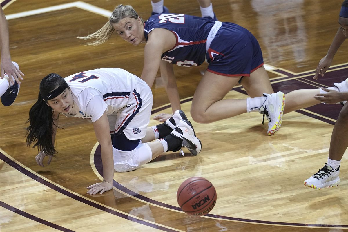 Gonzaga’s Kaylynne Truong (14) loses the ball as Belmont’s Conley Chinn (20) defends during the first half of a college basketball game in the first round of the women’s NCAA tournament at the University Events Center in San Marcos, Texas, Monday, March 22, 2021.  (Associated Press)