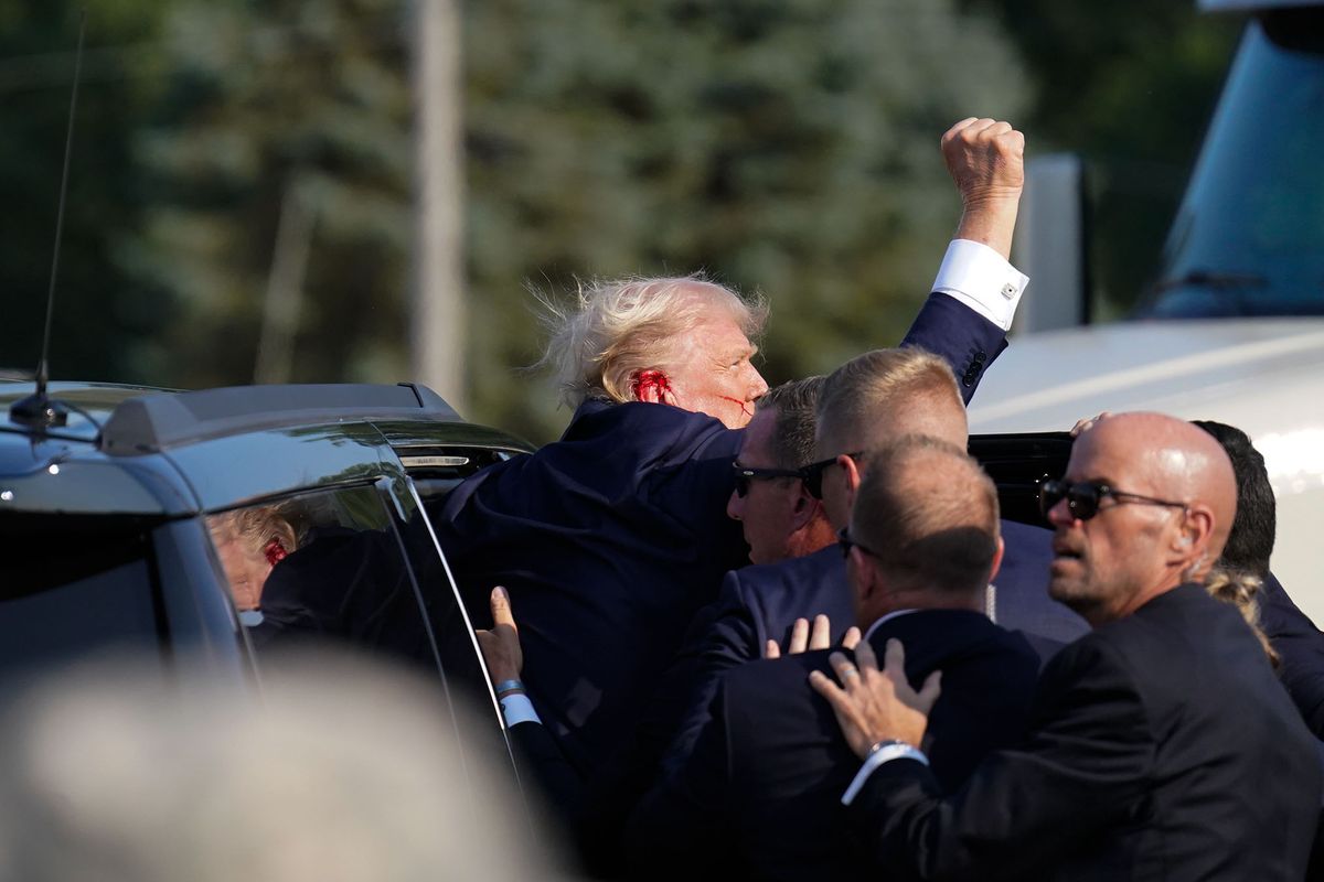Secret Service members help former president Donald Trump into a vehicle Saturday in Butler, Pa.  (Jabin Botsford/The Washington Post)