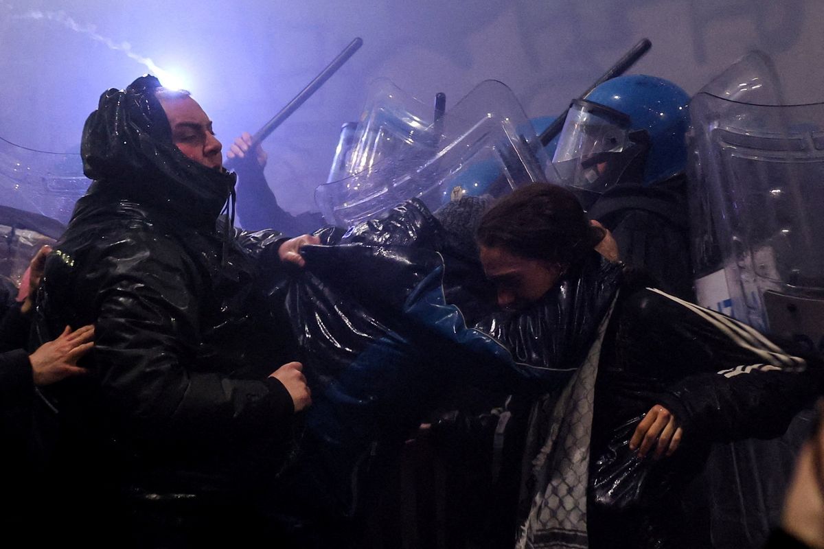 Police officers clash with demonstrators as they were trying to block a road leading to the Santa Giulia Arena on Sunday during protest against the environmental, economic and social impact of the Milano-Cortina 2026 Winter Olympics.  (Claudia Greco)