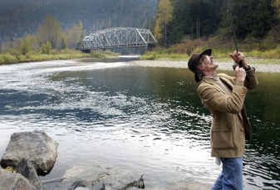 
Fisherman Eric Lafko of Nine Mile Falls, Wash., leans back to reel in a cutthroat trout Friday in the Coeur d'Alene National Forest east of Coeur d'Alene. 
 (Jesse Tinsley / The Spokesman-Review)