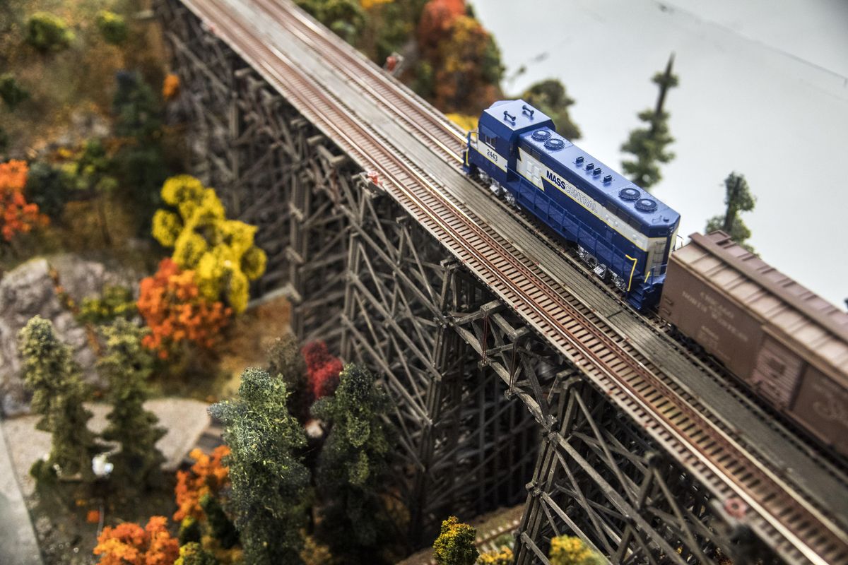 Alan Aston’s HO-scale Mass Central model train crosses Allan Cunningham’s Canyon Creek layout during the Spokane Model Train Show, Sunday, Oct. 15, 2017, at the Spokane County Fair & Expo Center. (Dan Pelle / The Spokesman-Review)