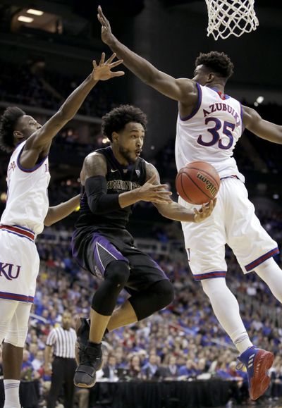 Washington’s David Crisp, center, gets past Kansas’ Marcus Garrett, left, and Udoka Azubuike (35) to pass the ball during the second half of an NCAA college basketball game Wednesday, Dec. 6, 2017, in Kansas City, Mo. Washington won 74-65. (Charlie Riedel / Associated Press)