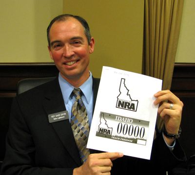 New Idaho Rep. Sage Dixon, R-Ponderay, with a mockup of his proposed new specialty license plate to benefit the Friends of the NRA. (BETSY Z. RUSSELL)