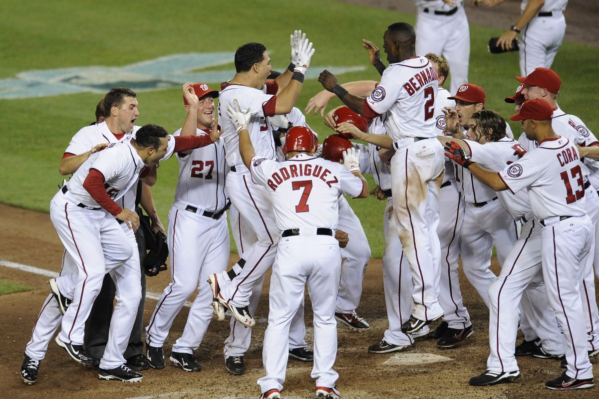 Nationals’ Wilson Ramos (3) is mobbed by teammates after he hit a three-run home run to beat the Mariners. (Associated Press)