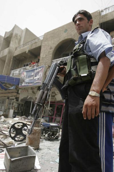 
An Iraqi police officer inspects damage from a suicide bomber Tuesday in Baghdad, Iraq. The bomber struck a restaurant. 
 (Associated Press / The Spokesman-Review)
